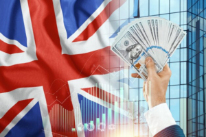 Money in a man's hand against the background of the flag of England