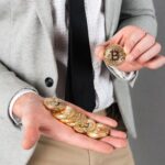 Close up of man holding stack of golden bitcoins